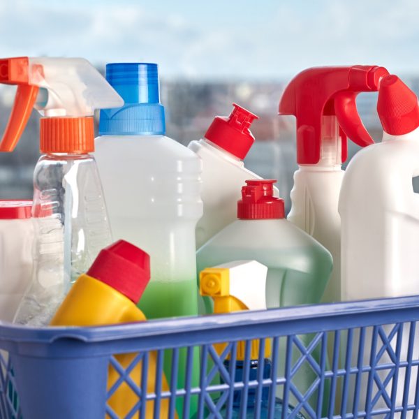 Cleaning supplies on wooden background.